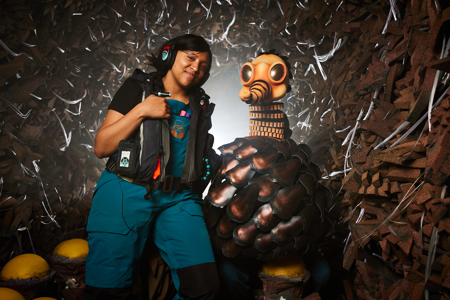 Issy, a black woman, smiling sitting next BOSSS